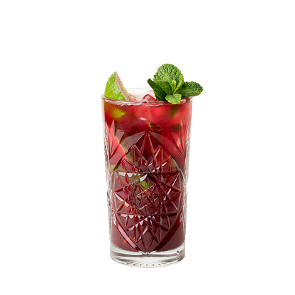 Cold multi fruit cocktail drink with slices of lime, mint leaf isolation on a white