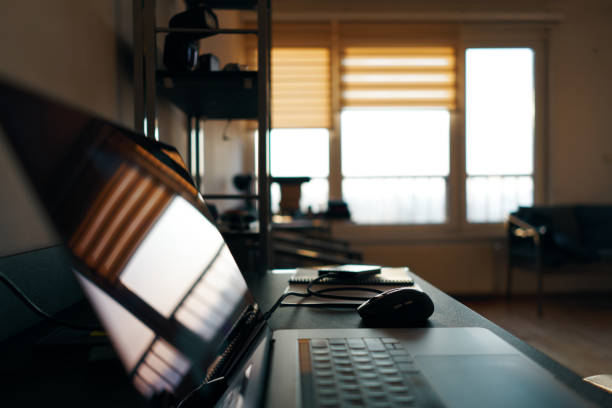 istock Small home office working environment during a cold sunny winter morning. A student's workplace at home with table and laptop 1212621198