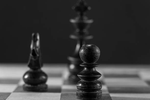 istock Image of Chess Pieces on Board for Game; black and white style 1212623304