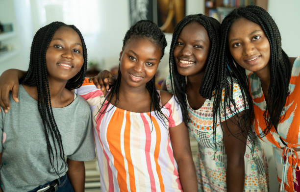 istock Four girlfriends embracing and taking selfie 1212623358