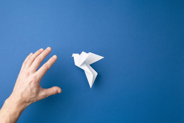 istock Paper pigeon on a blue isolated background. 1212624536