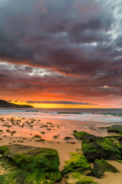 istock Clouds, rocks and the sea creating an atmospheric Sunrise Seascape 1212628203