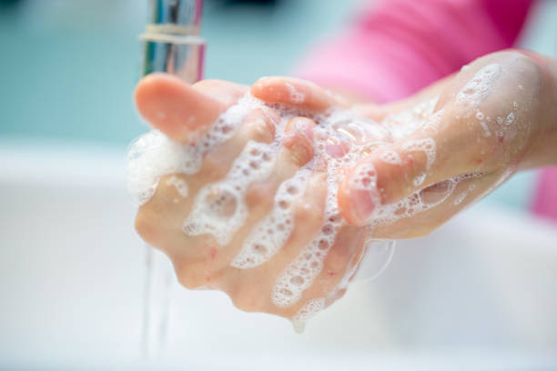 Little Girl washing hands with antibacterial soap Little Girl washing hands with antibacterial soap casarsaguru stock pictures, royalty-free photos & images