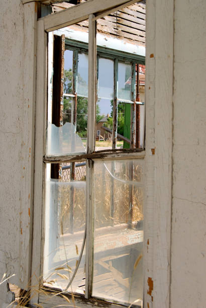 istock Closeup of broken windows in an old abandoned store 1212633045
