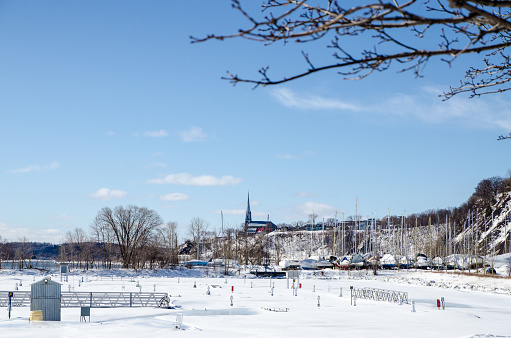 Sailboats stored in a marina of Quebec city during day of winter