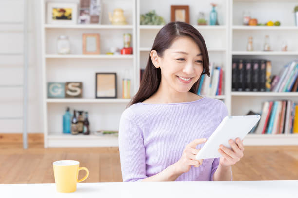istock asian woman to see a tablet computer 1212633209