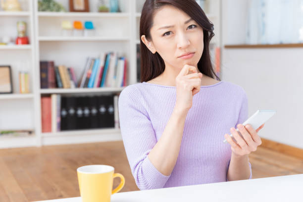 istock asian woman to see a smart phone,think, 1212633257