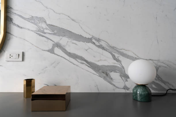 istock Composition of gold hexagon, rectangle stainless mirror and green marble table lamp with white marble on background / copy space / isolated object 1212636422