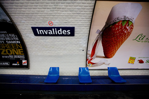 Empty seats and large advertisements at Invalides Metro station, Left Bank, Paris, France, Europe