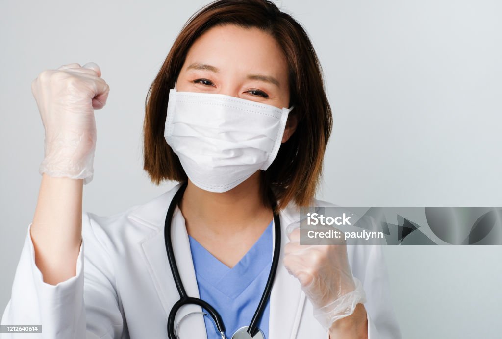 asian doctor wear the medical mask to protect and fight infection from germ, bacteria, covid19, corona , sars , influenza virus on white background with the happy face. Happiness Stock Photo