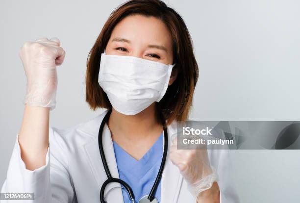 Asian Doctor Wear The Medical Mask To Protect And Fight Infection From Germ Bacteria Covid19 Corona Sars Influenza Virus On White Background With The Happy Face Stock Photo - Download Image Now