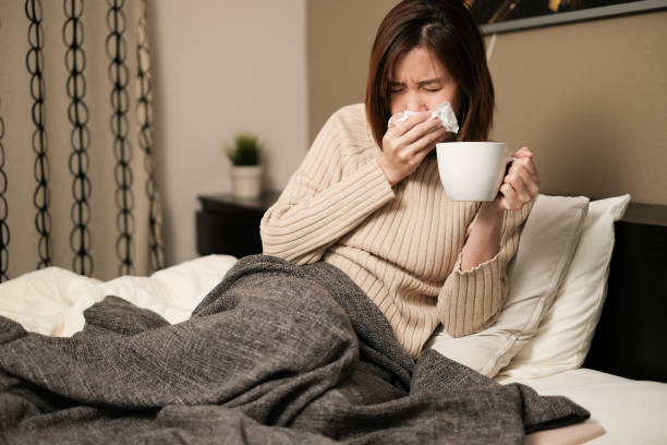 asian woman sneezing, fever, headache  and self quarantine at home .the infection from germ, bacteria, covid19, corona , sars , influenza virus on white background. sick and illness concept - cought imagens e fotografias de stock