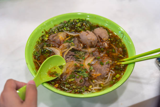 istock Human eating Vietnamese beef noodles- Bun Bo Hue 1212642282