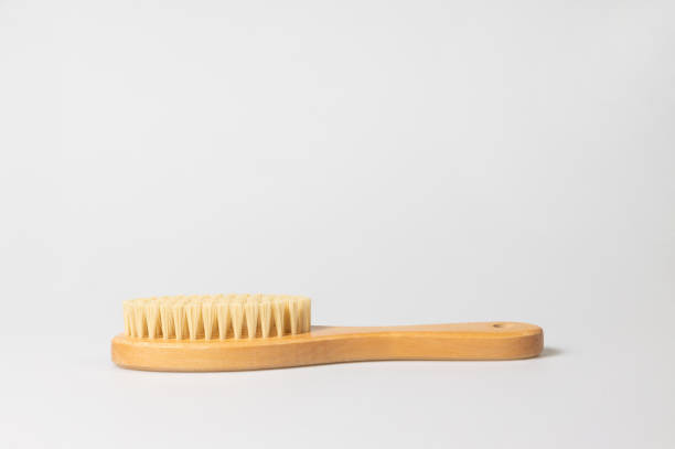side view of clothes brush with wooden handle on white background - hairstyle crest imagens e fotografias de stock