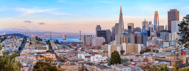 San Francisco skyline panorama at sunset with Bay Bridge and downtown skyline San Francisco city skyline panorama at sunset with downtown skyline and san francisco california stock pictures, royalty-free photos & images