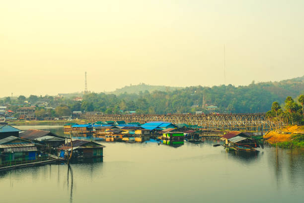 istock Houseboats and Mon bridge (Uttamanusorn Bridge) at Sam Pra Sob 1212648376