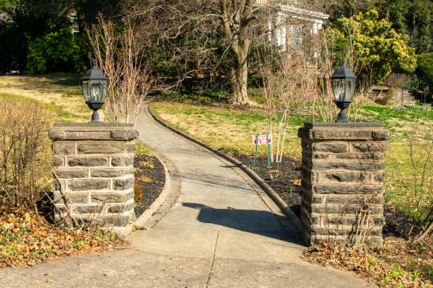 istock Two Stone Pillars With Lamps on Top and a Path In Between 1212648434