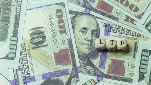 istock ltf  wooden cube on banknotes for business content. 1212650206