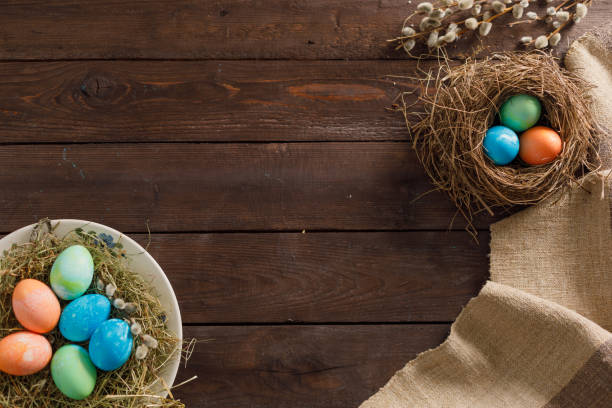 istock Still life many colorful easter eggs on a wooden background. Rustic. Decoration from natural fabrics and herbs. Easter celebration concept. Flat lay 1212651390