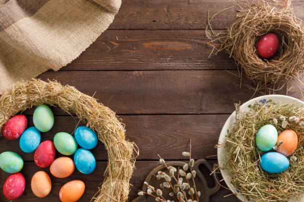 istock Still life many colorful easter eggs on a wooden background. Rustic. Decoration from natural fabrics and herbs. Easter celebration concept. Flat lay 1212651502