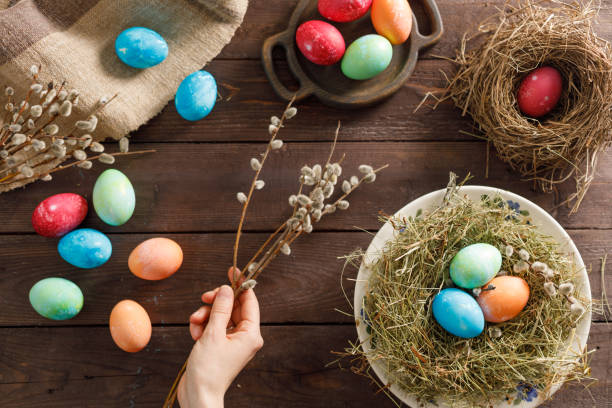 istock Still life many colorful easter eggs on a wooden background. Rustic. Decoration from natural fabrics and herbs. Easter celebration concept. Flat lay 1212652564