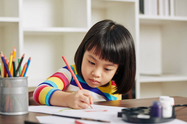 istock Serious drawing girl 1212654074