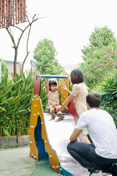 istock Parents and kid at playground 1212654121