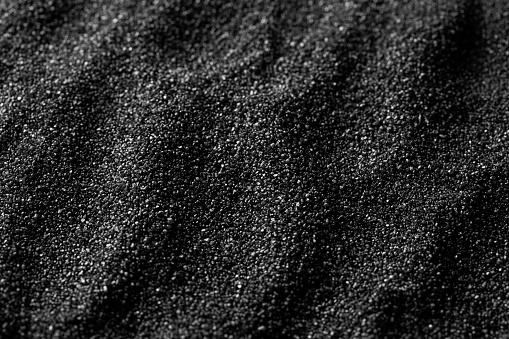 Black sand dunes background. Bump trace. Creative sand relief