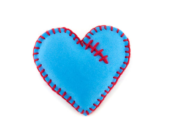 istock Handmade blue stitched toy heart on white 1212655041