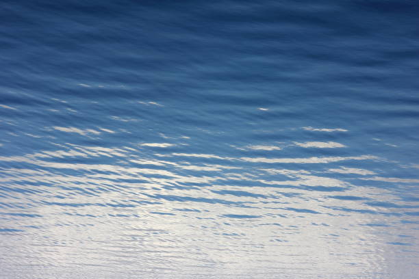istock view of calm blue water in a spring river with reflected clouds 1212655603