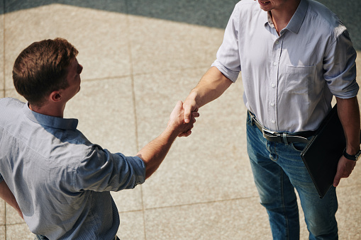 Cropped image of young entrepreneurs shaking hands when greeting each other before meeting