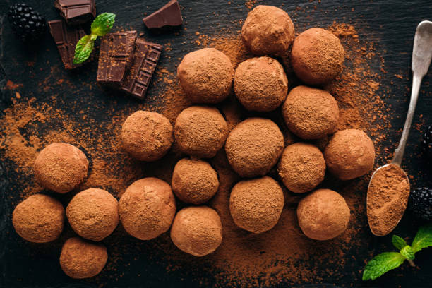 istock Chocolate truffles on black background 1212658692