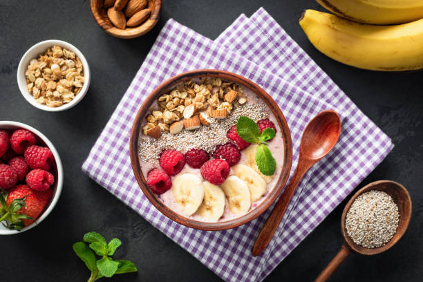 istock Pink smoothie bowl with raspberry banana 1212658716