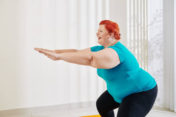 istock Overweight woman training legs 1212659914