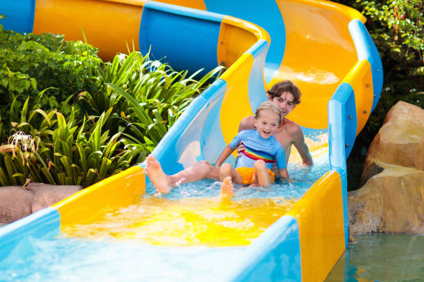 istock Kids on water slide in aqua park. Summer vacation 1212666113