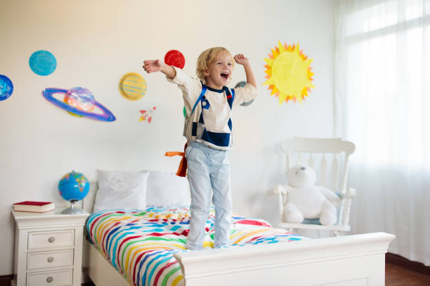 istock Kids play astronaut. Space and planet child game. 1212667124