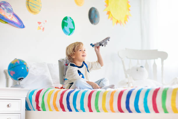 istock Kids play astronaut. Space and planet child game. 1212667659