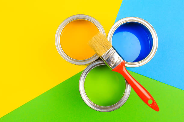 istock Metal paint cans and paint brushes on multicolor background. Top view. Copy space. 1212668075