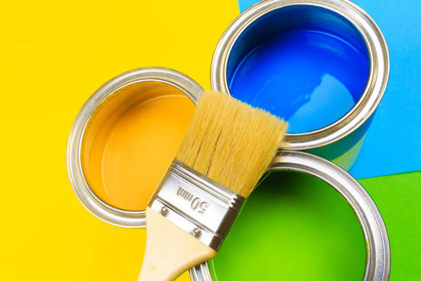 istock Metal paint cans and paint brushes on multicolor background. Top view. Copy space. 1212668131