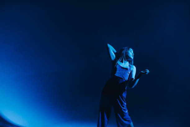 istock Young stylish girl dancing in the Studio on a colored neon background. Classic dancer. 1212668989