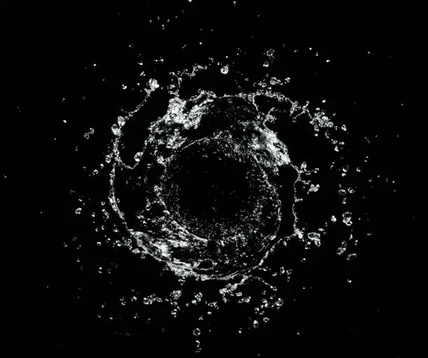 Abstract twister shape of water splash, isolated on black background. Freeze motion, energy and wash concept.