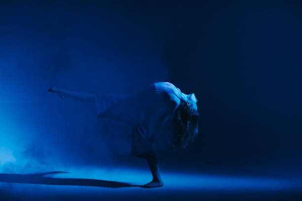 istock Young stylish girl dancing in the Studio on a colored neon background. Classic dancer. 1212669071