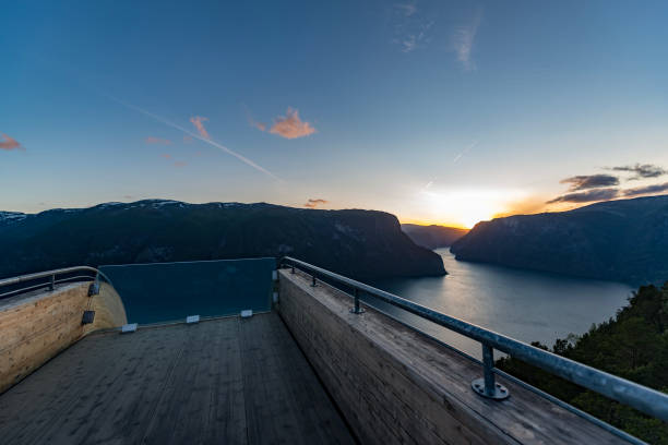 Stegastein viewpoint in Flåm, Norway with sunset. Architectonic viewpoint in Flåm, Norway, Stegastein. Sunset and Aurlandsfjord in the background stegastein viewpoint stock pictures, royalty-free photos & images