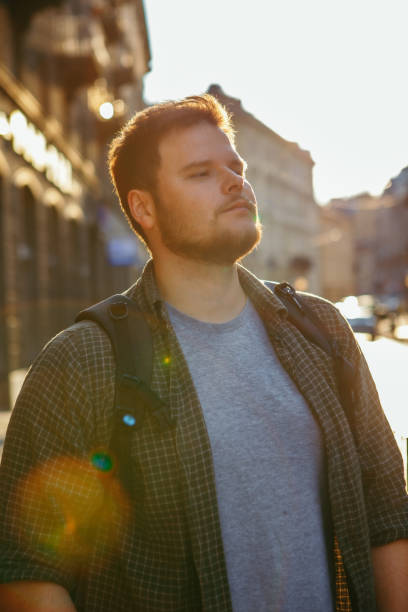 istock young bearded man at city street sunset 1212670182