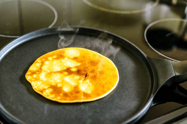 istock pancake frying pan with crepe pancake cooking on cooker in kitchen 1212670898