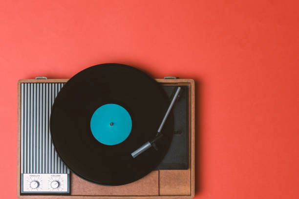 istock Vintage vinyl player and turnable on a orange background 1212671064