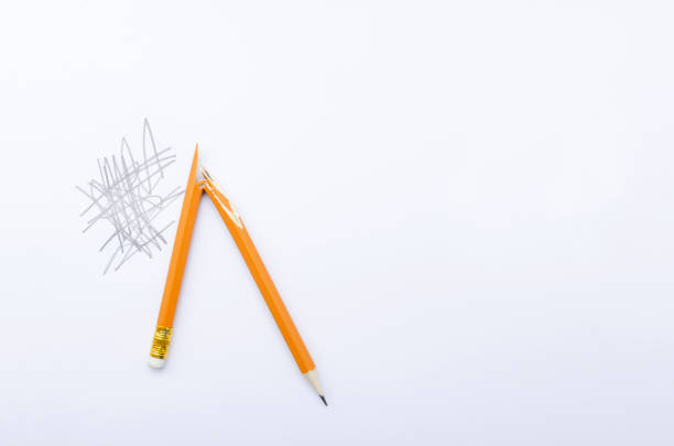 istock Top view of broken yellow pen and scratchy writing on the white paper/Empty space 1212673725