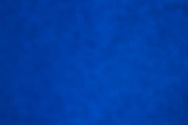 istock blue blur deep bokeh background with dark spots 1212673790