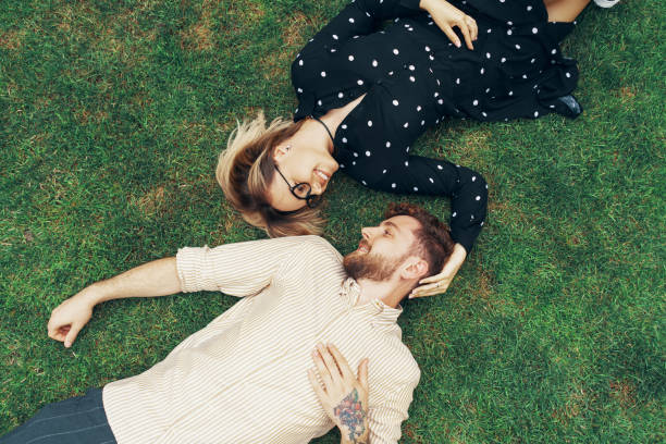 istock Couple in love lying on the grass 1212673829
