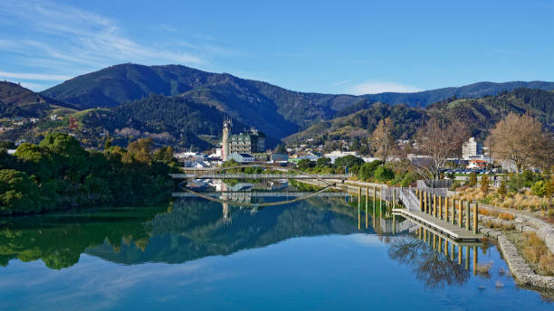 Panorama of Nelson City, reflected in the Maitai River, New Zealand. Panorama of Nelson City, reflected in the still waters of the Maitai River, New Zealand. nelson city new zealand stock pictures, royalty-free photos & images